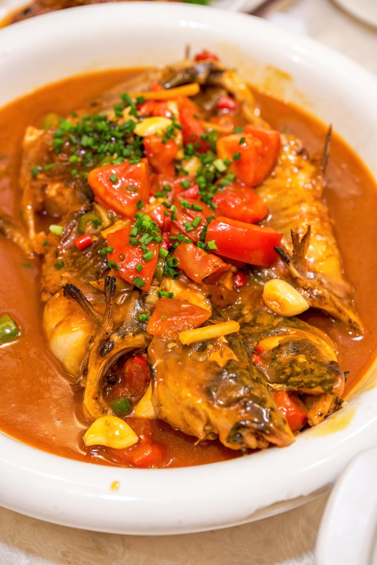 Closeup of Guilin’s best known specialties, beer fish with a tomato base